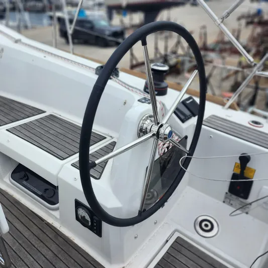 Skye Yacht Photos Pics Steering wheel of 2023 Jeanneau Sun Odyssey 349 sailboat, docked at marina.