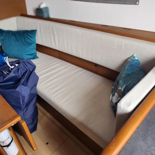 Skye Yacht Photos Pics Interior of 2023 Jeanneau Sun Odyssey 349 with cushioned seating and decorative pillows.