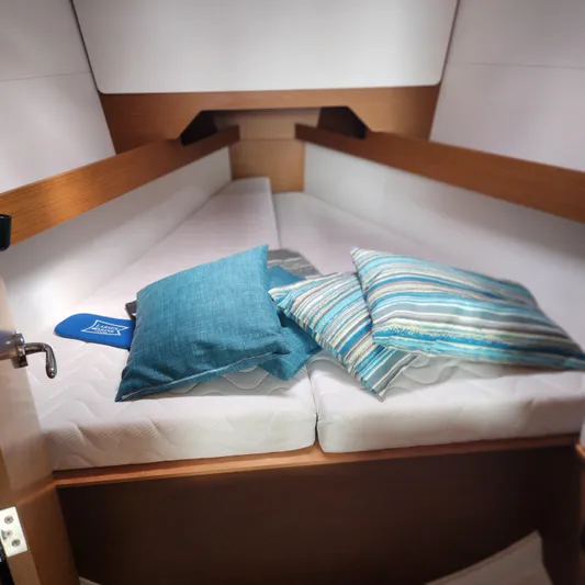 Skye Yacht Photos Pics 2023 Jeanneau Sun Odyssey 349 cabin with cozy bedding and pillows.