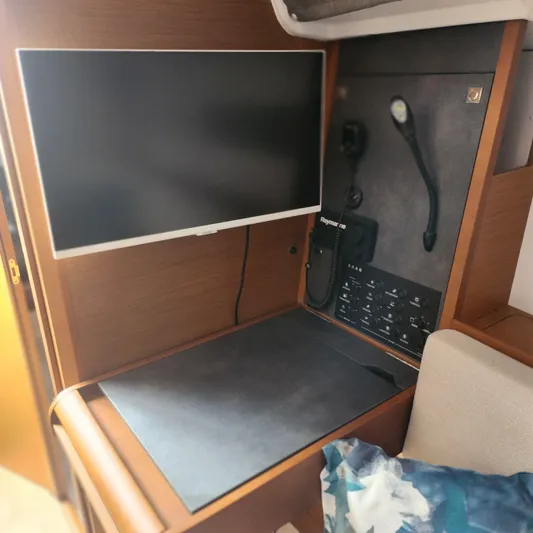 Skye Yacht Photos Pics Navigation station on 2023 Jeanneau Sun Odyssey 349 sailboat with control panel and screen.