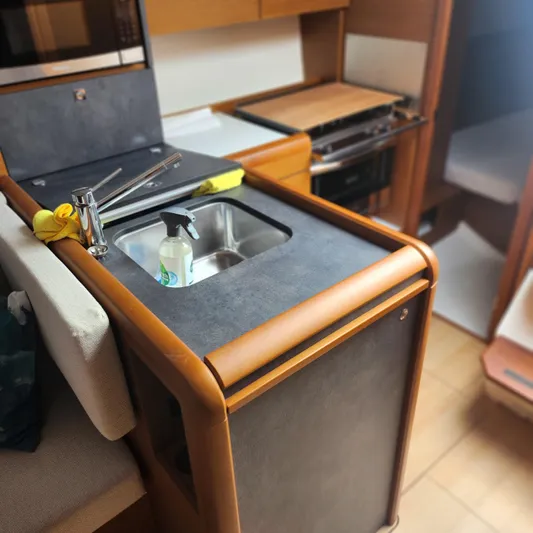 Skye Yacht Photos Pics 2023 Jeanneau Sun Odyssey 349 yacht interior with compact kitchen and sink.