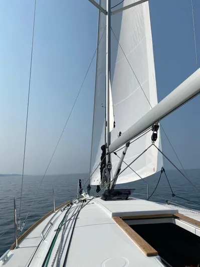 Skye Yacht Photos Pics 2023 Jeanneau Sun Odyssey 349 sailing on calm waters under clear skies.