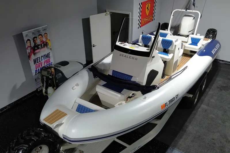 7.5m Hydrasol Rib Yacht Photos Pics 2021 Sealegs 7.5M RIB boat in showroom with blue seating and Ferrari poster.
