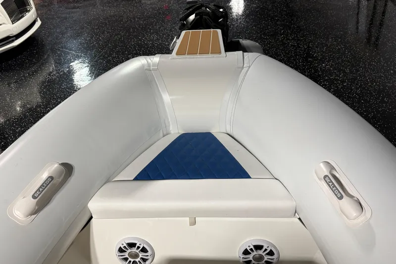 7.5m Hydrasol Rib Yacht Photos Pics 2021 Sealegs 7.5M RIB interior with blue and white seating, speakers, and Sealegs branding.