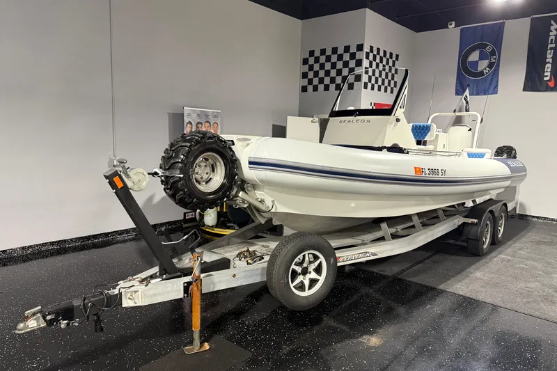 7.5m Hydrasol Rib Yacht Photos Pics 2021 Sealegs 7.5M RIB on trailer in showroom with checkered flag decor.