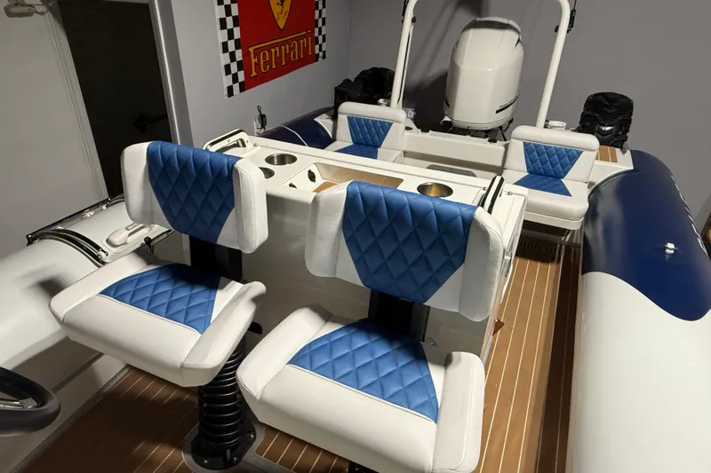 7.5m Hydrasol Rib Yacht Photos Pics 2021 Sealegs 7.5M RIB with blue and white seating, Ferrari poster in background.