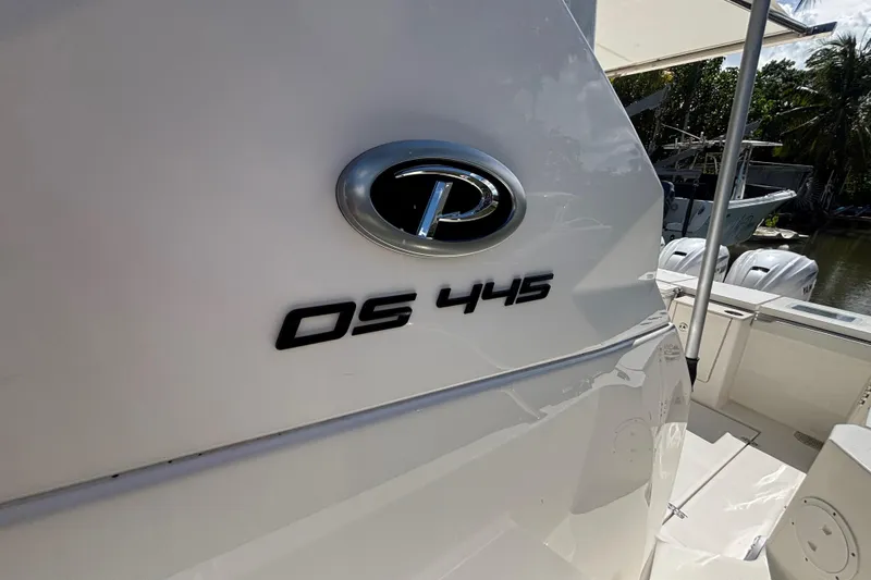  Yacht Photos Pics 2024 Pursuit OS 445 Offshore boat, close-up of model emblem and deck area.