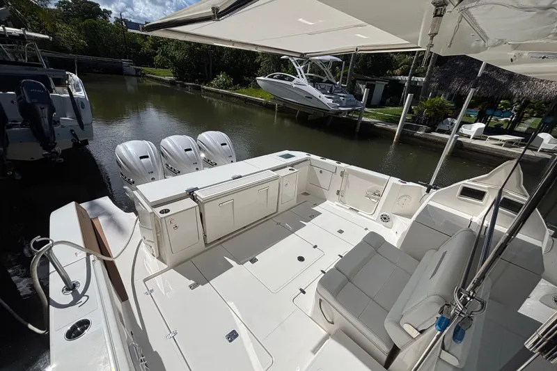  Yacht Photos Pics 2024 Pursuit OS 445 Offshore boat with spacious deck and triple outboard engines.