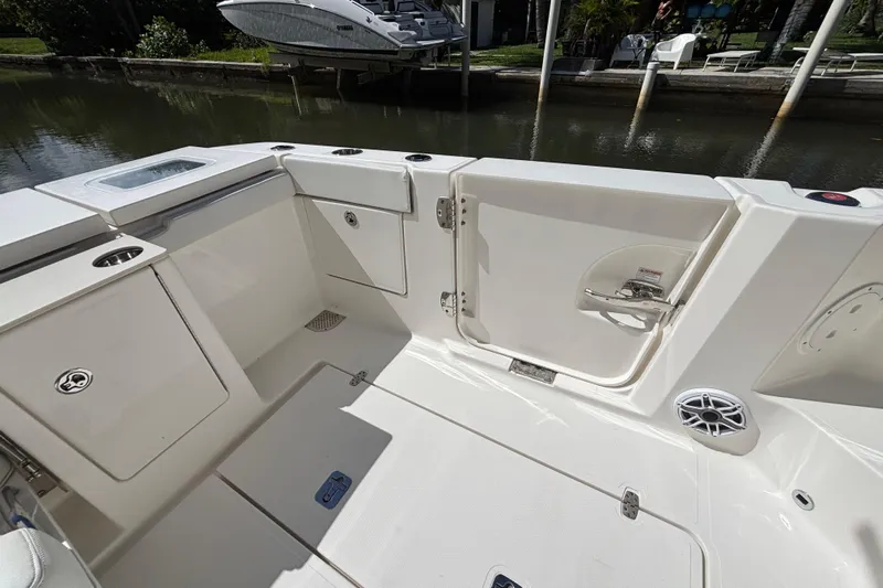  Yacht Photos Pics 2024 Pursuit OS 445 Offshore boat deck with storage compartments and sleek design.