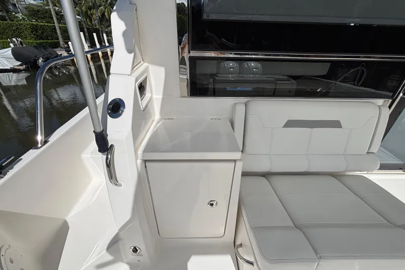  Yacht Photos Pics 2024 Pursuit OS 445 Offshore boat interior with white seating and storage area.