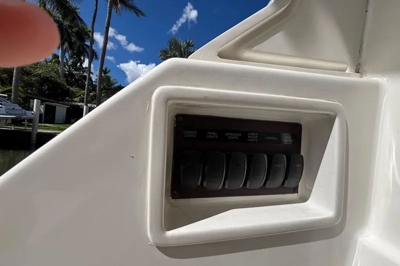  Yacht Photos Pics Control panel on 2024 Pursuit OS 445 Offshore boat, featuring various light switches.