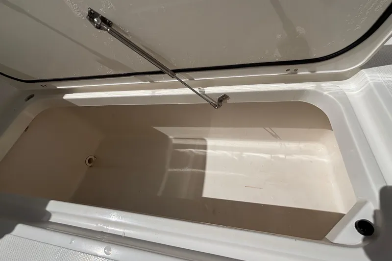  Yacht Photos Pics Open storage compartment on 2024 Pursuit OS 445 Offshore boat, showcasing interior space.