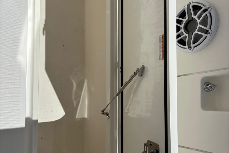  Yacht Photos Pics 2024 Pursuit OS 445 Offshore boat interior with speaker and storage compartment.