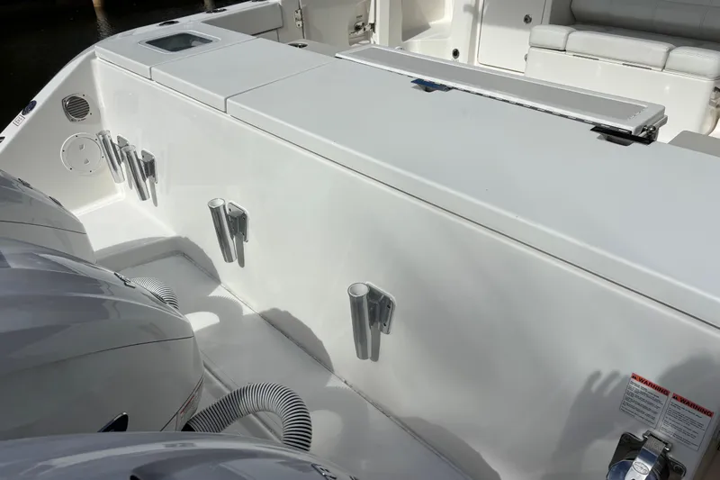  Yacht Photos Pics 2024 Pursuit OS 445 Offshore boat deck with rod holders and storage compartments.