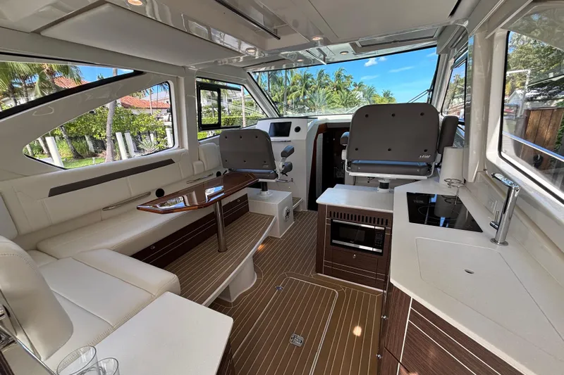  Yacht Photos Pics Luxurious interior of 2024 Pursuit OS 445 Offshore boat with modern amenities and seating.