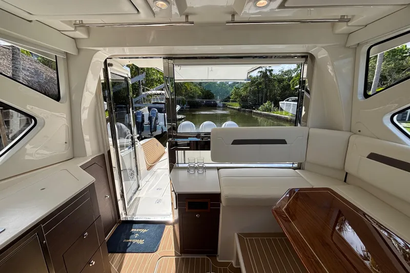  Yacht Photos Pics Luxurious interior of 2024 Pursuit OS 445 Offshore yacht with elegant seating and scenic water view.