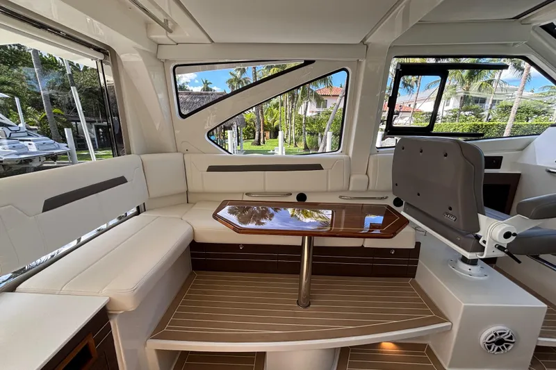  Yacht Photos Pics 2024 Pursuit OS 445 Offshore interior with elegant seating and polished wood table.