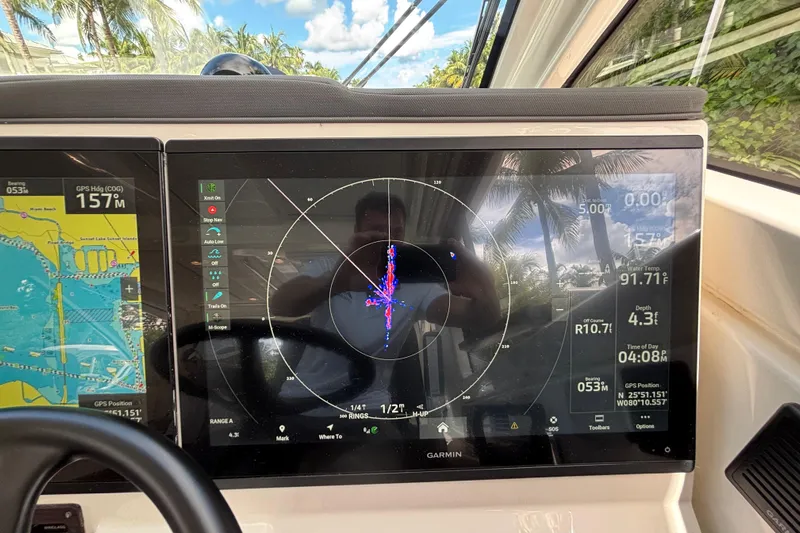  Yacht Photos Pics 2024 Pursuit OS 445 Offshore boat dashboard with Garmin navigation display.