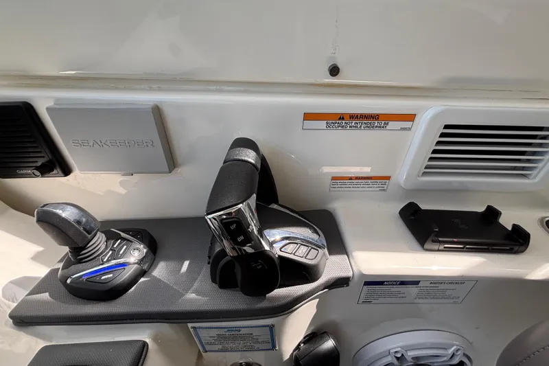  Yacht Photos Pics 2024 Pursuit OS 445 Offshore control panel with joystick and throttle levers.