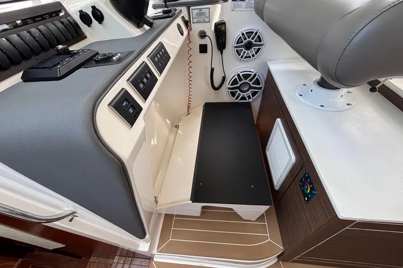  Yacht Photos Pics 2024 Pursuit OS 445 Offshore boat interior with control panel and seating area.