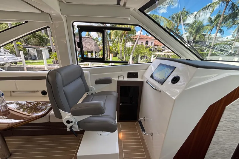  Yacht Photos Pics 2024 Pursuit OS 445 Offshore helm with luxurious seating and advanced navigation system.