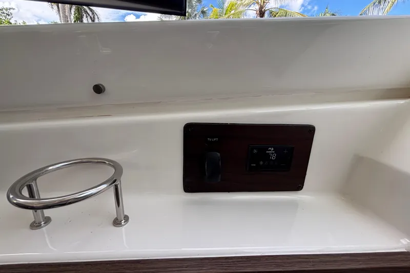  Yacht Photos Pics 2024 Pursuit OS 445 Offshore boat interior with control panel and cup holder.