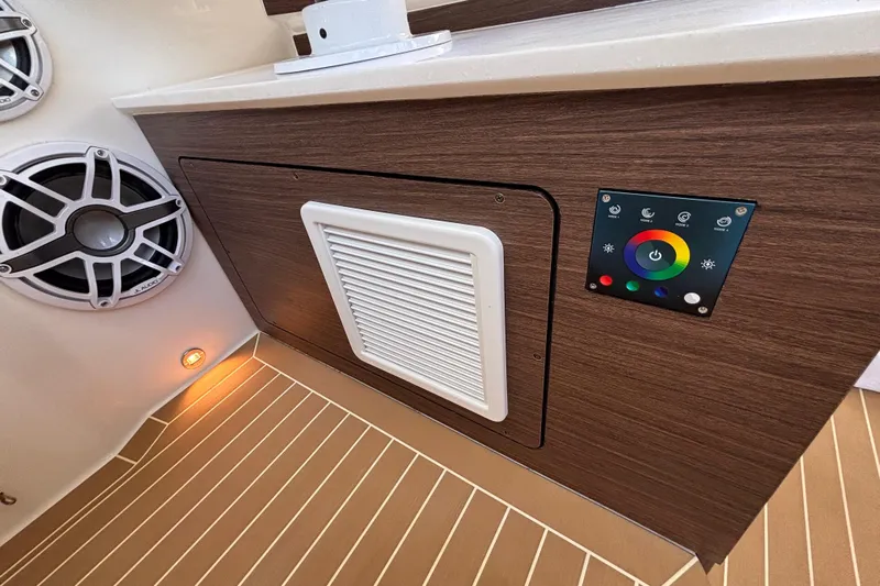  Yacht Photos Pics 2024 Pursuit OS 445 Offshore interior with speaker, control panel, and wood finish.