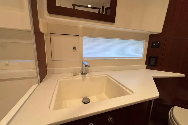  Yacht Photos Pics 2024 Pursuit OS 445 Offshore yacht bathroom with modern sink and sleek countertop design.