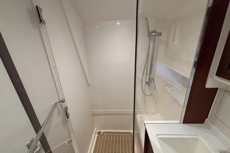  Yacht Photos Pics 2024 Pursuit OS 445 Offshore yacht bathroom with modern shower and sleek design.