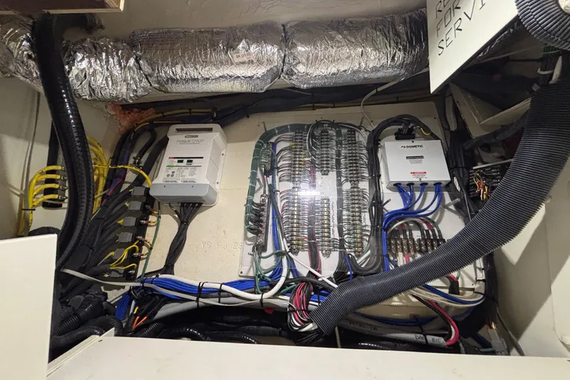  Yacht Photos Pics Electrical system of 2024 Pursuit OS 445 Offshore boat, featuring wiring and control panels.