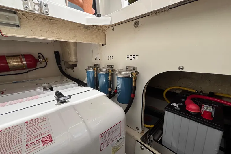  Yacht Photos Pics 2024 Pursuit OS 445 Offshore engine compartment with filters, battery, and fire extinguisher.