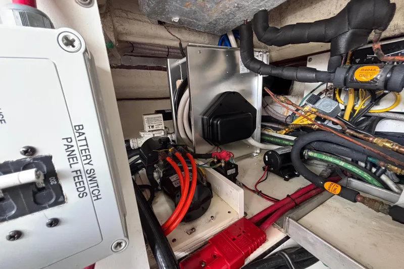  Yacht Photos Pics 2024 Pursuit OS 445 Offshore engine compartment with battery switch panel and wiring.