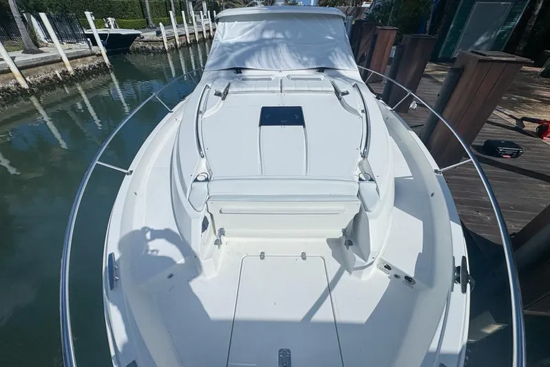  Yacht Photos Pics 2024 Pursuit OS 445 Offshore boat docked, showcasing sleek white deck design.