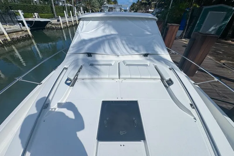  Yacht Photos Pics 2024 Pursuit OS 445 Offshore boat docked, showcasing sleek deck design and modern features.