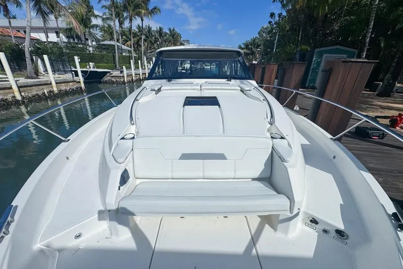  Yacht Photos Pics 2024 Pursuit OS 445 Offshore boat docked, showcasing sleek design and spacious deck.