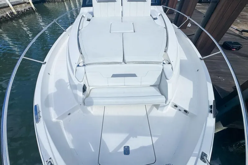  Yacht Photos Pics 2024 Pursuit OS 445 Offshore boat with spacious white seating area.