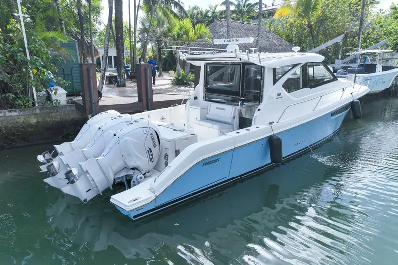  Yacht Photos Pics 2024 Pursuit OS 445 Offshore boat docked, featuring Yamaha engines and sleek design.