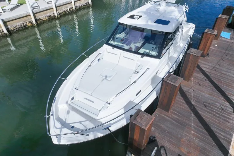  Yacht Photos Pics 2024 Pursuit OS 445 Offshore boat docked in marina, aerial view.