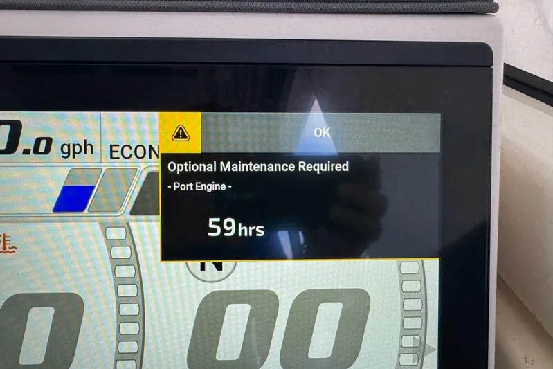  Yacht Photos Pics Display screen showing maintenance alert for 2024 Pursuit OS 445 Offshore port engine.