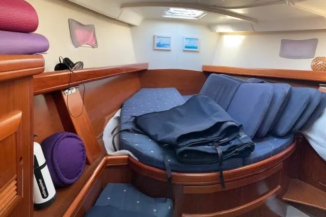  Yacht Photos Pics Cozy cabin interior of 2006 Beneteau Oceanis Clipper 473 sailboat with wooden furnishings.