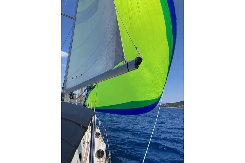  Yacht Photos Pics Sailing on a 2006 Beneteau Oceanis Clipper 473 with vibrant green spinnaker.