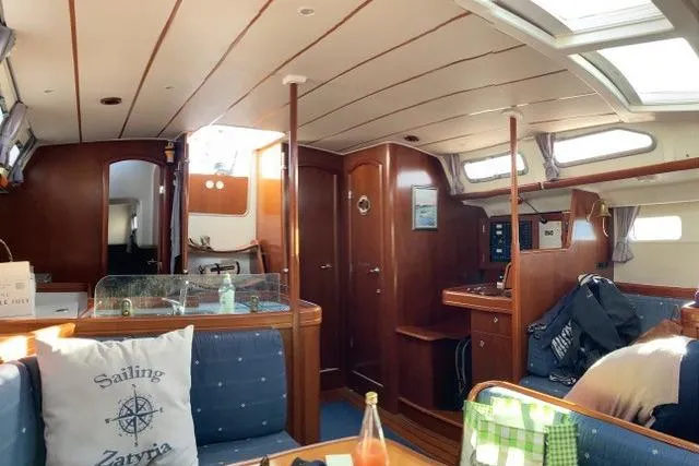  Yacht Photos Pics Interior of 2006 Beneteau Oceanis Clipper 473 sailboat, featuring wood paneling and cozy seating.