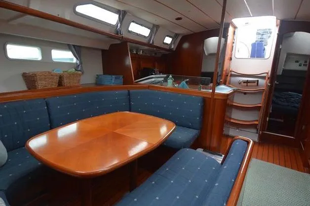  Yacht Photos Pics 2006 Beneteau Oceanis Clipper 473 interior with dining area and wooden finishes.