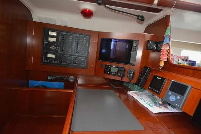  Yacht Photos Pics Navigation station of 2006 Beneteau Oceanis Clipper 473 yacht with control panels and instruments.