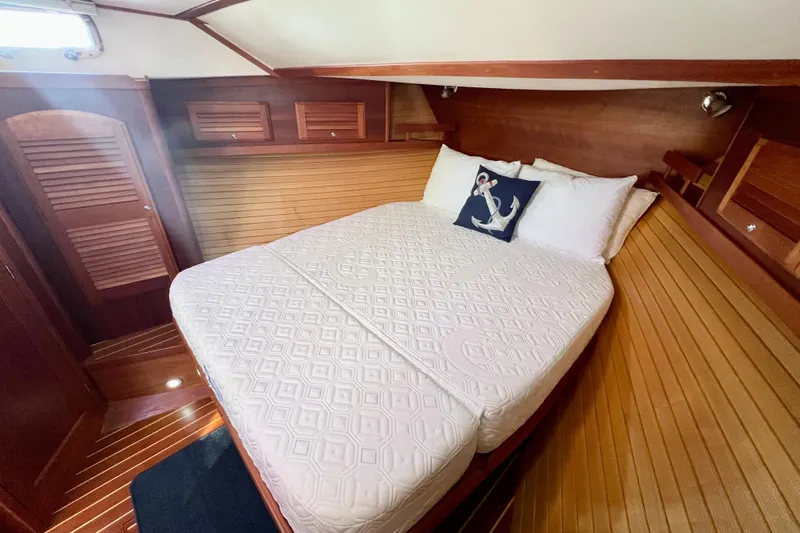 Island Time Yacht Photos Pics Cozy cabin interior of 2006 Sabre 38 Hard Top Express with wooden finish and nautical decor.