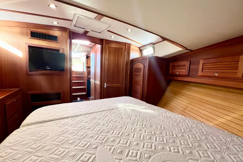Island Time Yacht Photos Pics 2006 Sabre 38 Hard Top Express cabin with wood interior and cozy bedding.