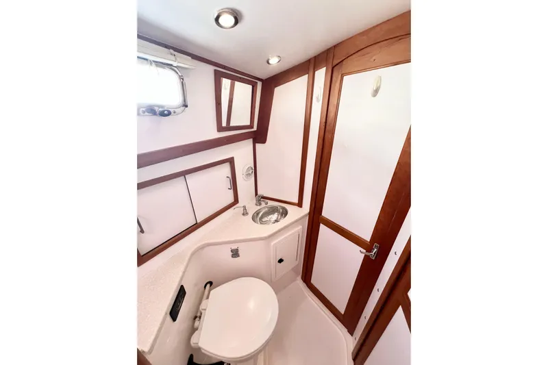 Island Time Yacht Photos Pics 2006 Sabre 38 Hard Top Express yacht bathroom with wood accents and modern fixtures.
