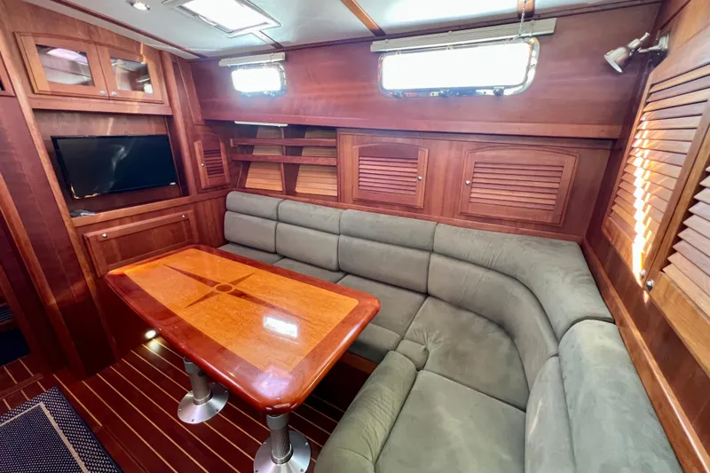 Island Time Yacht Photos Pics Luxurious interior of 2006 Sabre 38 Hard Top Express yacht with plush seating and wooden accents.