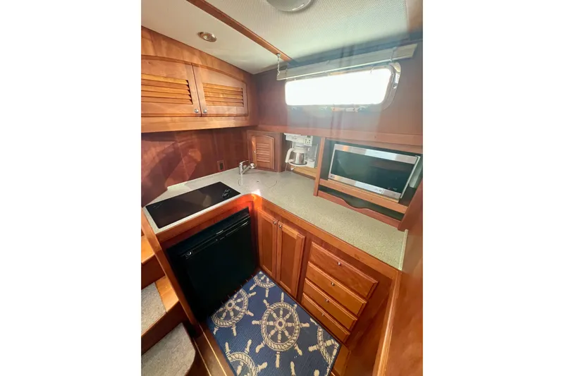 Island Time Yacht Photos Pics 2006 Sabre 38 Hard Top Express yacht kitchen with wood cabinetry and modern appliances.