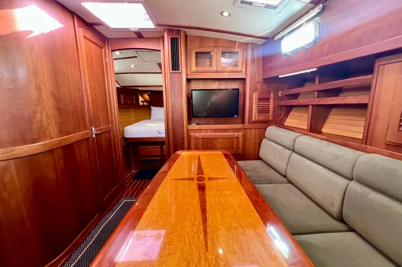 Island Time Yacht Photos Pics 2006 Sabre 38 Hard Top Express interior with wood finish, sofa, and TV.